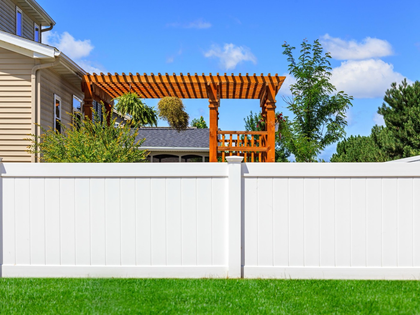 White vinyl privacy fence installed in a London backyard